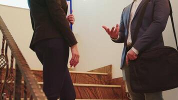 Business woman and executive manager shaking hands while standing on stairs discussing in office building . Group of professional businesspeople working in modern financial workplace. video