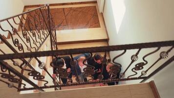 Top view of business colleagues coming to office climbing up together on stairs in finance corporate company. Group of professional successful businesspeople working in modern financial building. video