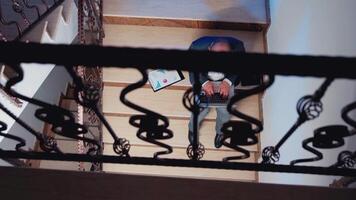 Top view of overworked tired businessman at workplace typing on notebook for job project sitting on stairwell. Confident corporate entrepreneur using laptop doing overtime in business building. video