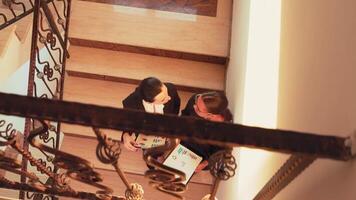 Top view of women colleagues meeting on stairs, talking about corporate project in business building. Group of professional successful businesspeople working together in modern financial workplace. video