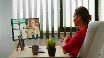 Woman talking with colleagues about project on call. Freelancer working with business remotely team discussing chatting having virtual online conference meeting webinar using internet technology video