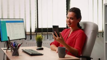 Freelancer talking with colleague using phone webcam in modern office. Entrepreneur working with business remotely team discussing chatting having online conference, webinar with internet technology video