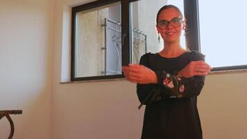 Portrait of woman office manager looking to camera having good mood standing on stairs in corporate finance building. Entrepreneur, leader, manager, office executive posing in office on staircase. video