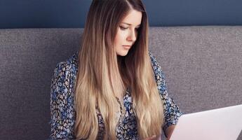 Beautiful woman working at computer desk, from home, female student masters degree course, laptop for elearning, university education, language school or online shopping photo