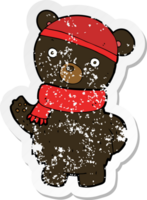 pegatina retro angustiada de un oso negro de dibujos animados con sombrero de invierno y bufanda png