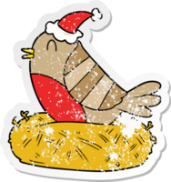 hand drawn distressed sticker cartoon of a bird sitting on nest wearing santa hat png