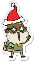 hand drawn sticker cartoon of a joyful man with beard and parcel under arm wearing santa hat png