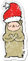 distressed sticker of a cartoon bear wearing christmas hat png