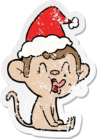 crazy hand drawn distressed sticker cartoon of a monkey sitting wearing santa hat png