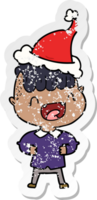 hand drawn distressed sticker cartoon of a happy boy laughing wearing santa hat png