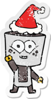 happy distressed sticker cartoon of a robot waving hello wearing santa hat png