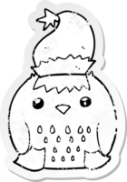 distressed sticker of a cute cartoon owl wearing christmas hat png