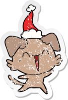 happy little dog distressed sticker cartoon of a wearing santa hat png