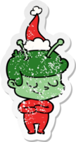 friendly distressed sticker cartoon of a spaceman wearing santa hat png