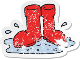 retro distressed sticker of a cartoon wellington boots in puddle png