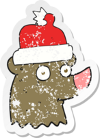 retro distressed sticker of a cartoon bear wearing christmas hat png