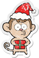 main tiré affligé autocollant dessin animé de une Noël singe portant Père Noël chapeau png