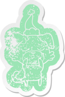 schattig eigenzinnig tekenfilm verontrust sticker van een hond vervelend de kerstman hoed png