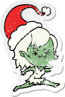 annoyed hand drawn distressed sticker cartoon of a vampire girl wearing santa hat png