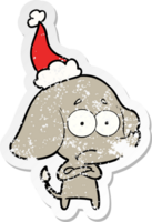 hand drawn distressed sticker cartoon of a unsure elephant wearing santa hat png