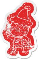 quirky cartoon distressed sticker of a bearded man with present wearing santa hat png