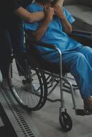 Doctor giving hope. Close up shot of young female physician leaning forward to smiling elderly lady patient holding her hand in palms. Woman caretaker in white coat supporting encouraging old person photo