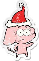 hand drawn distressed sticker cartoon of a unsure elephant wearing santa hat png