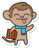 sticker of a funny cartoon monkey with christmas present png