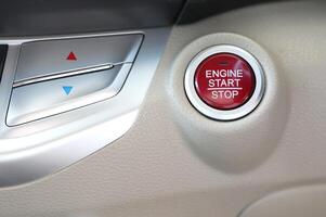 Red engine start stop button in modern car photo