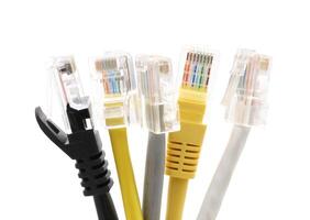 Multi colored network cables with molded RJ45 plug isolated on white background photo