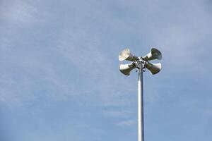 Horn speaker in the park with blue sky background photo