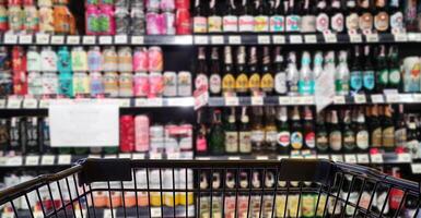 Abstract blurred image of alcohol store with trolley in department store photo