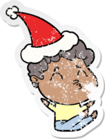 hand drawn distressed sticker cartoon of a man pouting wearing santa hat png