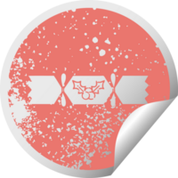 distressed circular peeling sticker symbol of a christmas cracker png