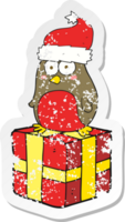 retro distressed sticker of a cartoon robin on present png