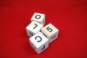 Educational stacking cube toy made of wood with numbers and letters photo