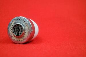 The head of the sink drain. used condition. red background photo