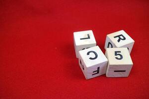 Educational stacking cube toy made of wood with numbers and letters photo