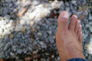 a man legs in dark brown. Asian man. gravel background photo