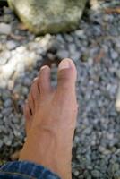 a man legs in dark brown. Asian man. gravel background photo