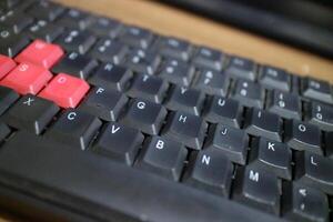 a black computer keyboard, slightly dusty photo