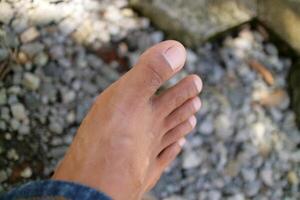 a man legs in dark brown. Asian man. gravel background photo