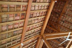 The roof of a simple building, the frame is made of wood. Roof tiles are made from clay photo