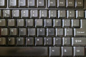 a black computer keyboard, slightly dusty photo