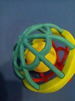 Ball toy with colorful plastic spokes with a loud sound for babies photo