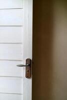 a white wooden door with white walls. with door handles made of aluminum photo