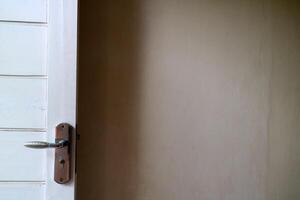 a white wooden door with white walls. with door handles made of aluminum photo