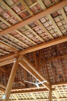 The roof of a simple building, the frame is made of wood. Roof tiles are made from clay photo