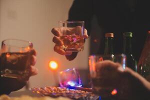 Celebration night, pour whiskey into a glass. Give to friends who come to celebrate photo