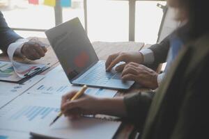 Co working conference, Business team meeting present, investor colleagues discussing new plan financial graph data on office table with laptop and digital tablet, Finance, accounting, investment. photo